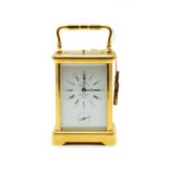 A lacquered brass carriage clock,