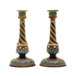 A pair of Doulton Lambeth stoneware candlesticks,
