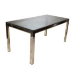 A chrome and brass dining table,