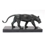 A bronze of a prowling lioness