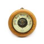 A 1920's oak cased aneroid barometer,