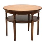 An Arts & Crafts circular oak two-tier centre table,
