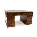 An early 20th century mahogany partners desk,
