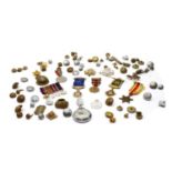 A collection of military badges buttons and medals,