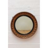 A Regency-style giltwood convex mirror,