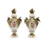 A pair of Continental lidded porcelain urns,
