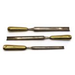 A graduated set of three brass and steel shipwright's gouges,