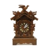 A wooden Black Forest cuckoo clock,