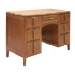 A Cotswold School oak kneehole desk,