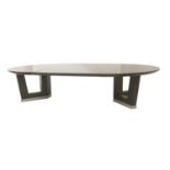 A contemporary ebonised ash extending dining table,