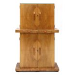 An Art Deco walnut two-part cocktail cabinet,