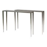 A pair of contemporary moulded aluminium console tables,