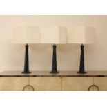 A set of three Maison Charles 'Pyramide' patinated bronze table lamps,