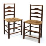 A pair of Arts and Crafts oak chairs,