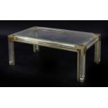 A Lucite and brass coffee table,