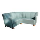 A turquoise upholstered corner settee,