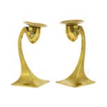 A pair of Arts and Crafts brass candlesticks,