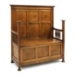 An Arts and Crafts oak settle,