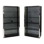 A pair of smoked glass and chrome display cabinets,