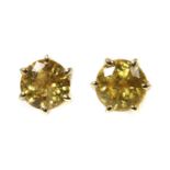 A pair of gold single stone yellow sapphire stud earrings