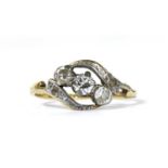 A gold three stone diamond crossover ring,