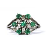 A silver emerald and diamond cluster ring,