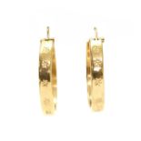 A pair of gold hollow hoop earrings,