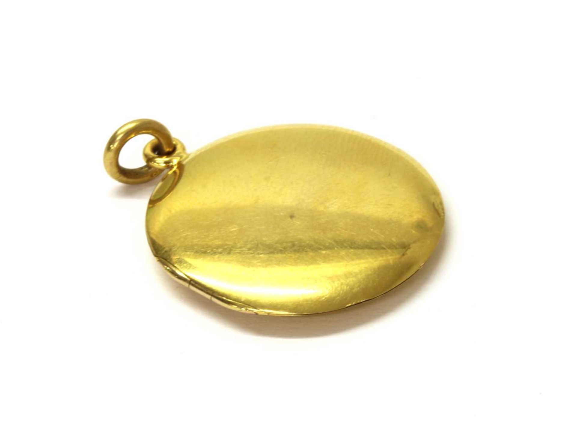 An 18ct gold circular locket,