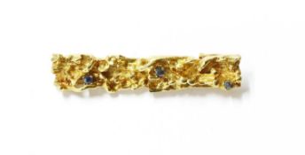 A gold sapphire set bar brooch,