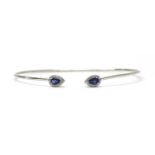 A silver sapphire and diamond torque bangle,