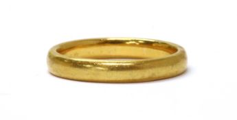A 22ct gold court section wedding ring,