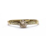 A gold single stone diamond ring,