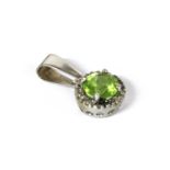 A white gold peridot and diamond cluster pendant,