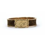 A gold and woven hair memorial or love token ring,