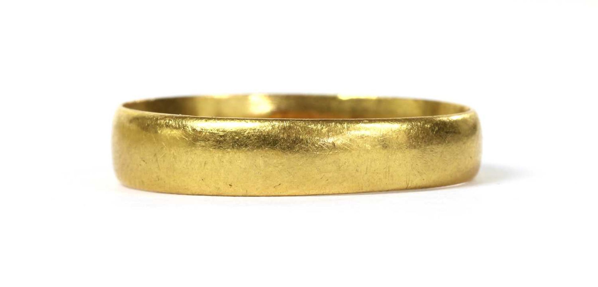 A 22ct gold flat section wedding ring,