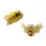 Two French Art Nouveau carved horn brooches,