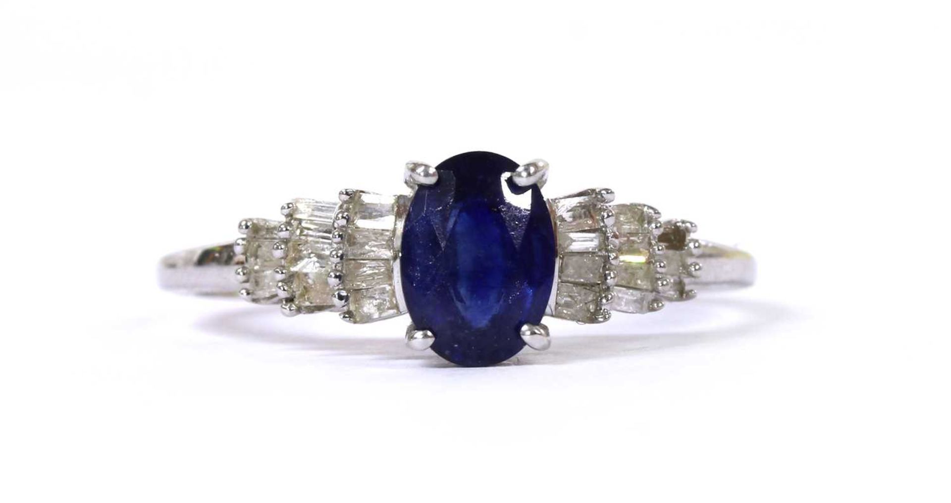 A white gold fracture filled sapphire and diamond ring,
