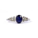 A white gold fracture filled sapphire and diamond ring,