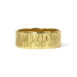 An 18ct gold patterned flat section wedding ring,