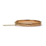 A 9ct gold hollow oval hinged bangle,