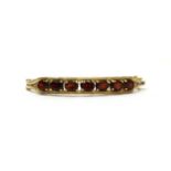 A gold garnet bangle,