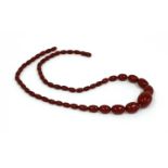 A single row graduated cherry coloured Bakelite bead necklace,