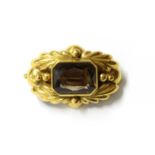 A gold smoky quartz brooch,