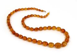 A single row graduated faceted cognac amber bead necklace,