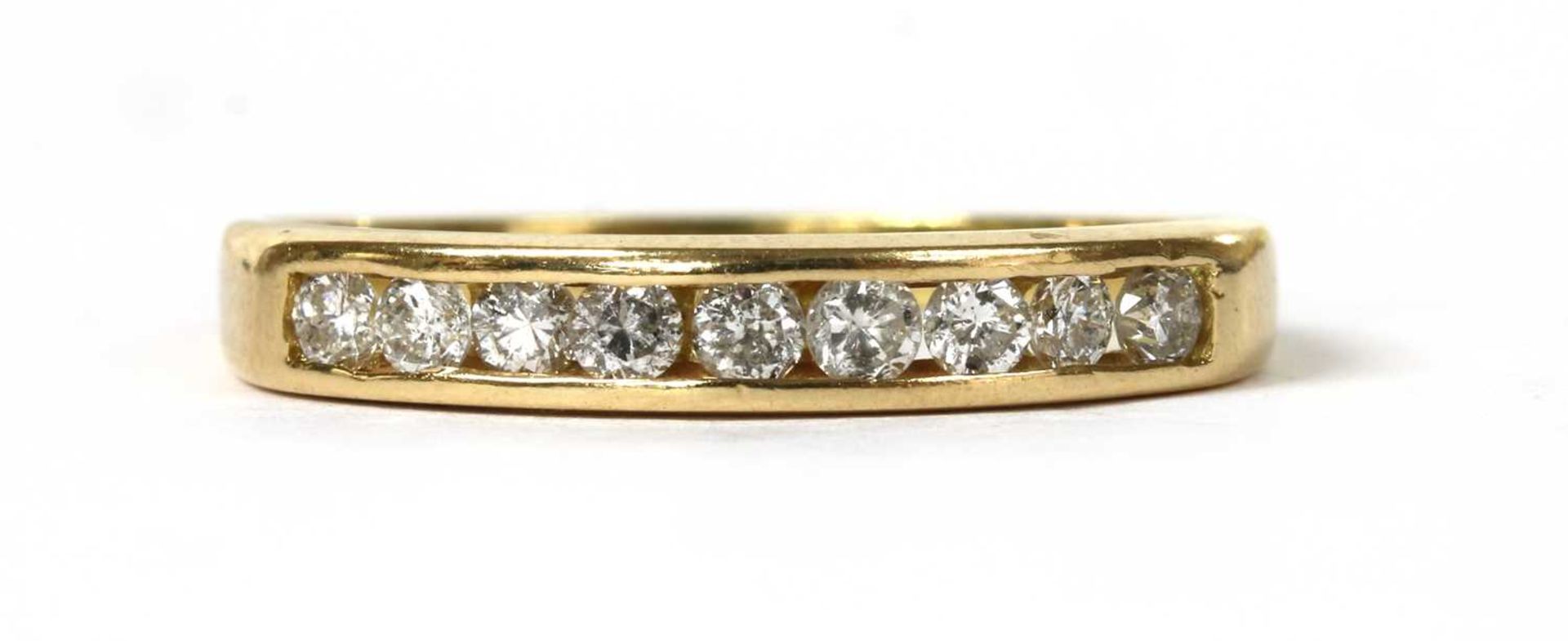 A gold diamond half eternity ring,