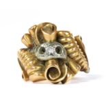 A gold diamond set scroll ring,