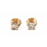 A pair of rose gold single stone diamond stud earrings,