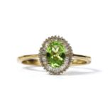 A gold peridot and diamond cluster ring,