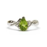 A white gold peridot and diamond ring,