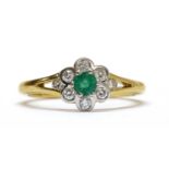 An 18ct gold emerald and diamond daisy cluster ring,